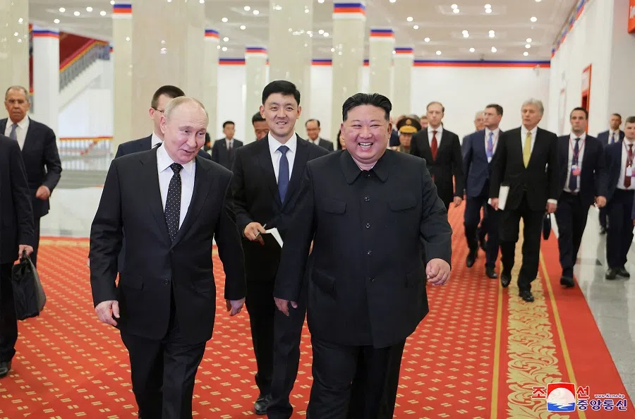 This picture taken on 19 June 2024 and released on 20 June 2024 from North Korea’s official Korean Central News Agency (KCNA) via KNS shows North Korea’s leader Kim Jong Un and Russia’s President Vladimir Putin speaking after watching the welcome performance at the Pyongyang Gymnasium in Pyongyang.