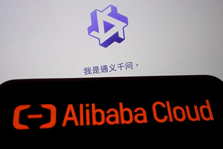 The Alibaba Cloud logo is displayed near a screen showing the website of its Tongyi Qianwen AI chatbot, in this illustration picture taken on 28 June 2023. (Florence Lo/Illustration/Reuters)