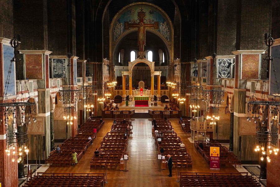 A picture shows worshipers attending Westminster Cathedral in London on 15 June 2020 after the church reopened for private prayer. (William Edwards/AFP)