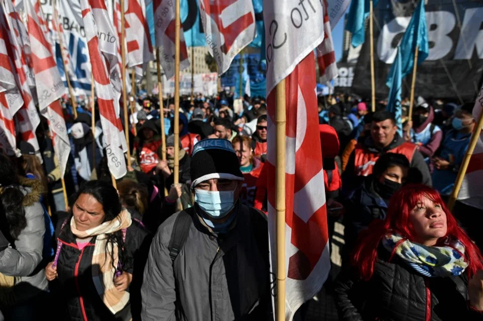 Members of social organisations demonstrate after camping overnight at Plaza de Mayo square in front of Casa Rosada Presidential Palace in Buenos Aires on 11 August 2022, during a protest demanding better wages and more jobs and a meeting with Argentina's new economy minister Sergio Massa. Argentina has suffered years of economic crisis, with some 37% of its population now living in poverty. Inflation for the first half of this year alone topped 36%. (Luis Robayo/AFP)
