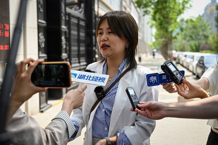 Xu Zaozao speaks to the media before a second hearing of her case suing a Beijing hospital for refusing to freeze her eggs on the basis that she is unmarried, at the No. 3 Intermediate People's Court in Beijing, China, on 9 May 2023. (Jade Gao/AFP)