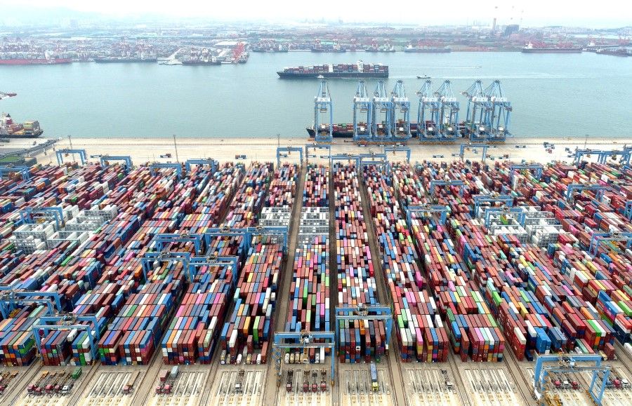 An aerial view shows containers and cargo vessels at the Qingdao port in Shandong province, China, 9 May 2022. (China Daily via Reuters)