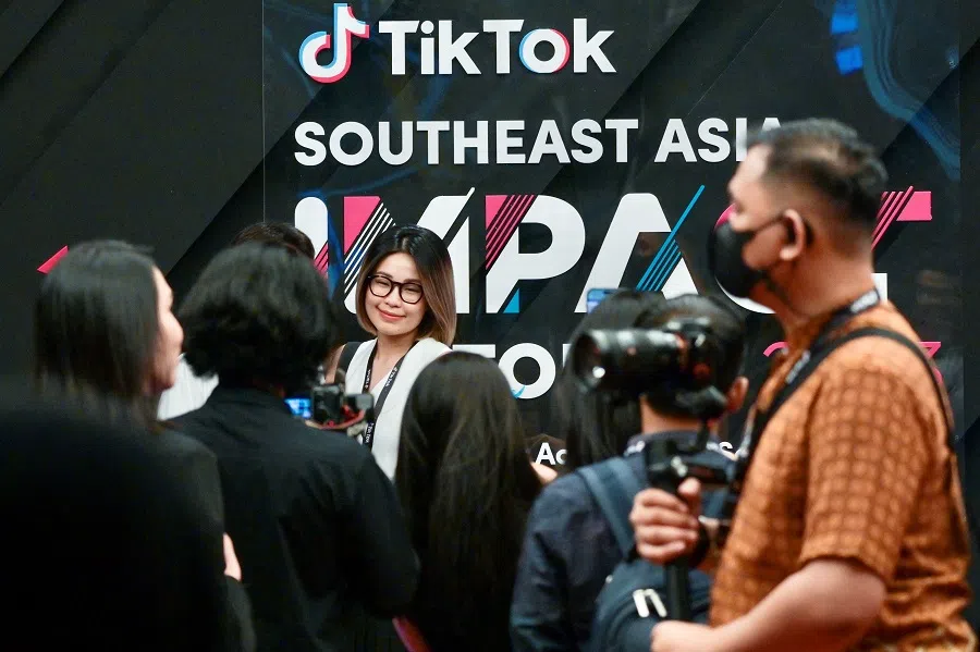 A woman poses in front of signage before the TikTok Southeast Asia Impact Forum 2023 in Jakarta, Indonesia, on 15 June 2023. (Bay Ismoyo/AFP)