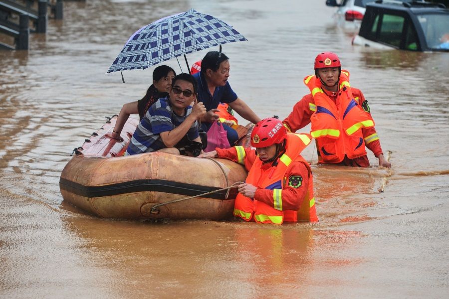 Rescuers evacuate flood-affected residents following heavy rain in Jiujiang, Jiangxi province on 8 July 2020. (STR/AFP)