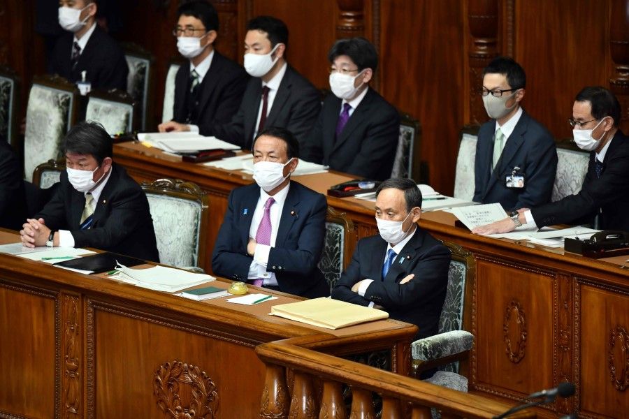 Japan's Prime Minister Yoshihide Suga (front right), Finance Minister Taro Aso (front centre) and Foreign Minister Toshimitsu Motegi (front left) attend the opening session of the lower house of parliament in Tokyo on 18 January 2021. (Kazuhiro Nogi/AFP)