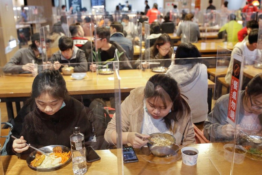 Students eat lunch between dividers to protect them from the coronavirus disease (COVID-19) in the canteen of the National Taiwan University of Science and Technology (NTUST) in Taipei, Taiwan April 6, 2020. (Ann Wang/REUTERS)