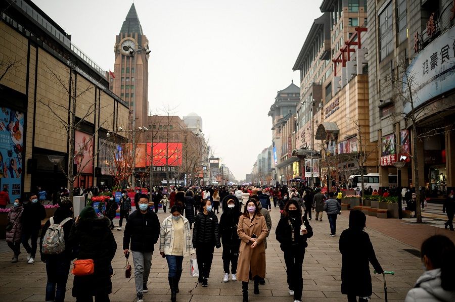 People walk along Wangfujing shopping street in Beijing, China, on 14 February 2021. (Noel Celis/AFP)