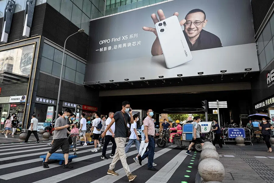 This photo taken on 12 July 2022 shows people walking along Huaqiangbei Commercial Street in Shenzhen, Guangdong province, China. (Jade Gao/AFP)