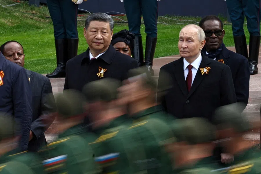 Russian President Vladimir Putin and Chinese President Xi Jinping watch Russian service members marching past during a flower-laying ceremony at the Tomb of the Unknown Soldier on Victory Day, marking the 80th anniversary of the victory over Nazi Germany in World War II, in central Moscow, Russia, on 9 May 2025. (Evgenia Novozhenina/Reuters)