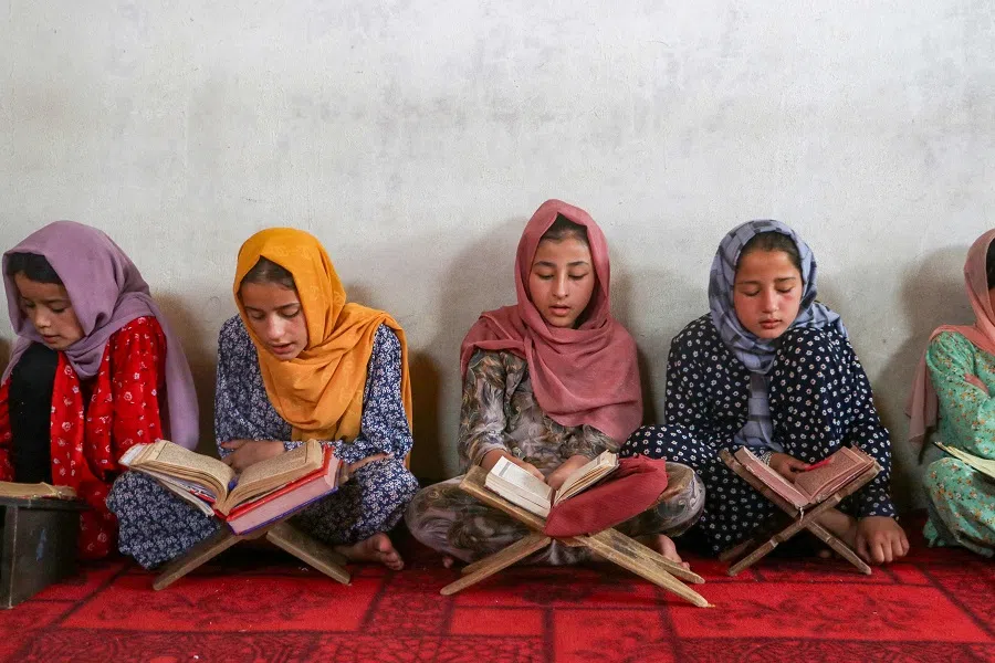 In this photo taken on 24 July 2024, Afghan girls read the holy Quran at a madrassa (Islamic school) in the Faizabad district of Badakhshan province. (Omer Abrar/AFP)