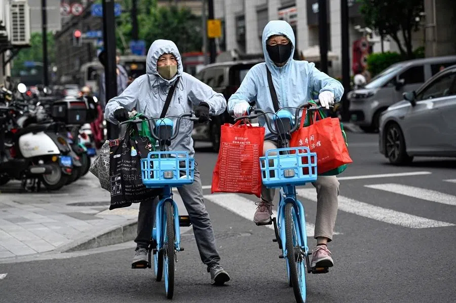 People ride bicycles on a street in Shanghai on 2 June 2026.