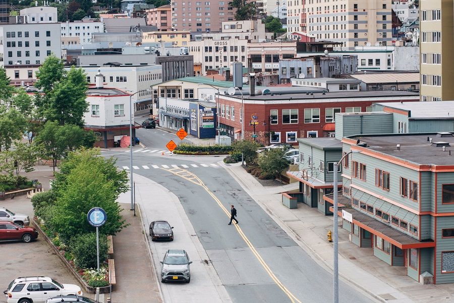 A pedestrian crosses an empty street in downtown Juneau, Alaska, US, on 22 July 2020. (Meg Roussos/Bloomberg)