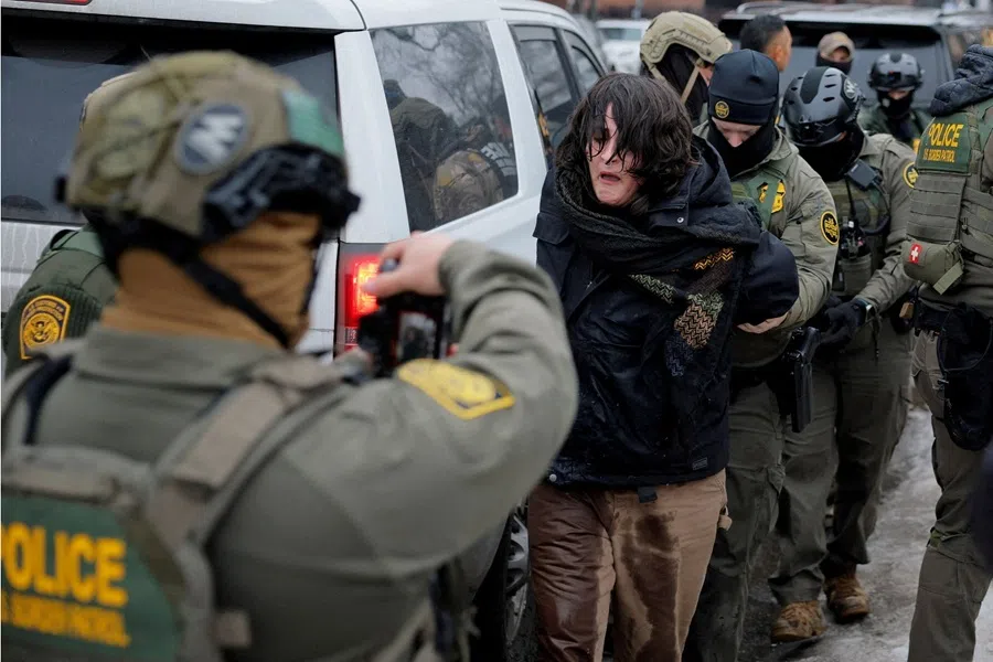 US Border Patrol Agents working with Border Patrol commander Greg Bovino detain a protestor, a day after the fatal shooting of Renee Good by a US Immigration and Customs Enforcement agent, in Minneapolis, Minnesota, US, 8 January 2026.