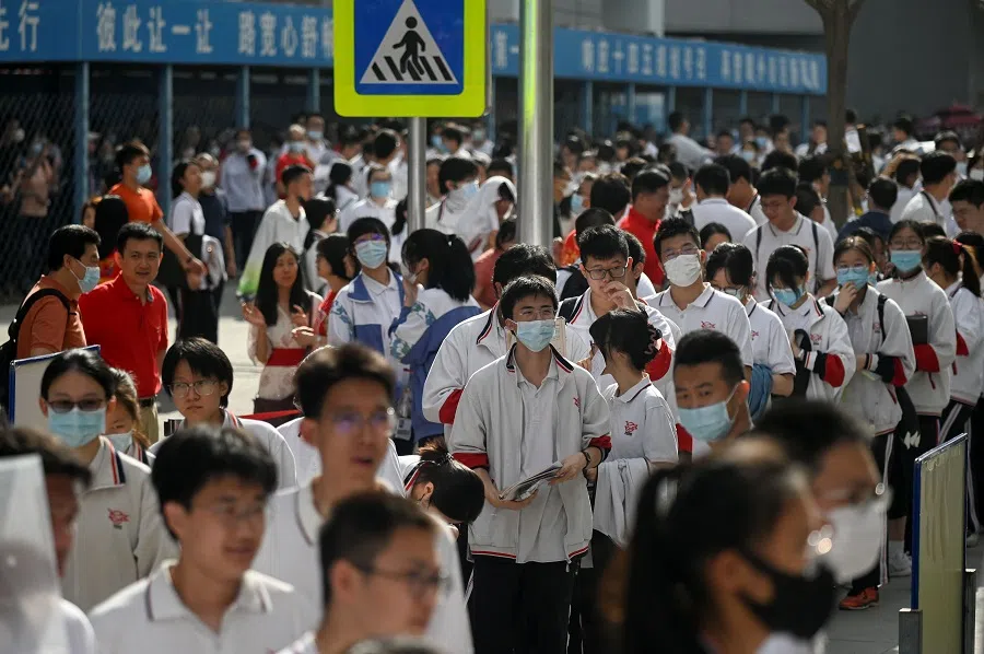 Students line up to enter a school on the first day of China's national college entrance examination, known as the gaokao, in Beijing, China on 7 June 2023. (Wang Zhao/AFP)