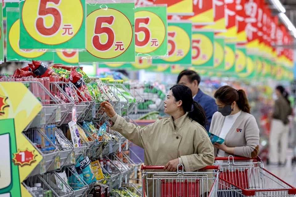 People shopping at a supermarket in Zaozhuang, in eastern China’s Shandong province on 10 April 2025. (Stringer/AFP)