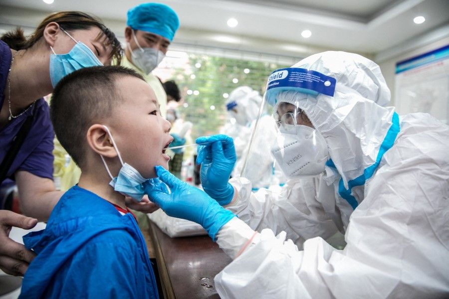 This photo taken on 8 August 2021 shows a child being given a nucleic acid test for the Covid-19 coronavirus in Nantong, in China's eastern Jiangsu province. (STR/AFP)
