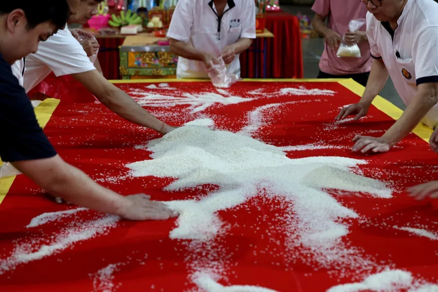 After the ritual, the rice drawing is swept back into a pile of rice, and then divided into small bags for devotees to take home.