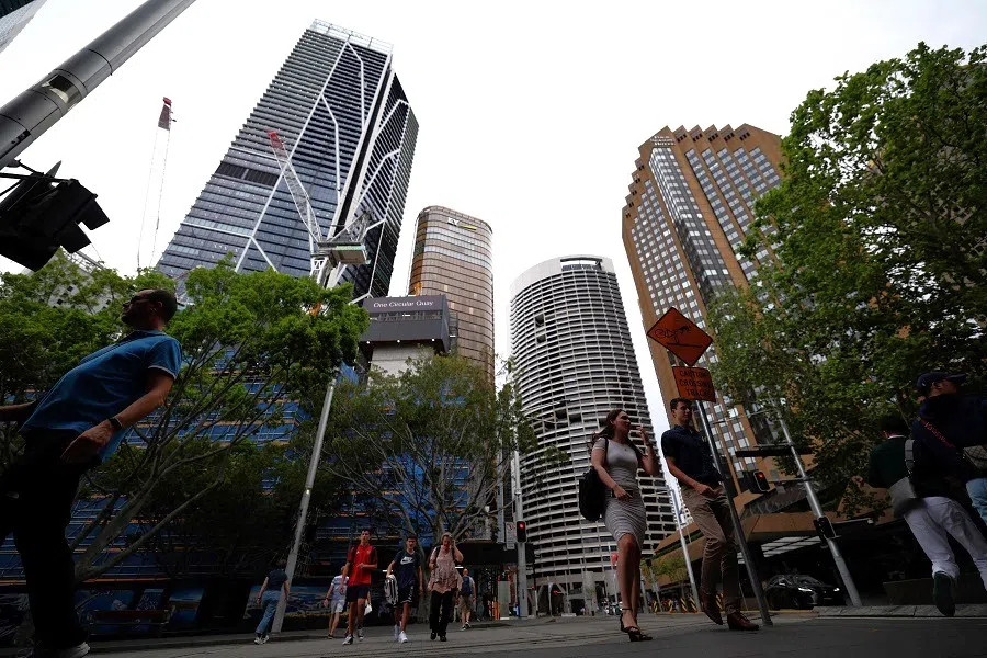 People walk through the central business district in Sydney, Australia, on 4 October 2023. (Saeed Khan/AFP)