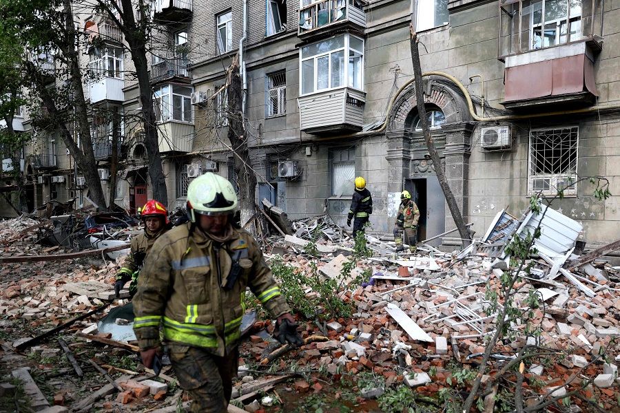 Ukrainian rescuers work in the courtyard of a residential building damaged as a result of a missile attack in Dnipro on 19 April 2024, amid the Russian invasion of Ukraine. (Anatolii Stepanov/AFP)