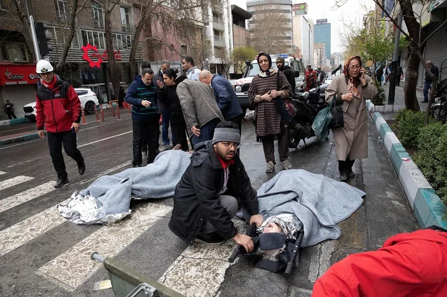 People reacting next to casualties in the aftermath of a strike carried out during the 40-day US-Israeli conflict with Iran, in Tehran, Iran, in March-April 2026.