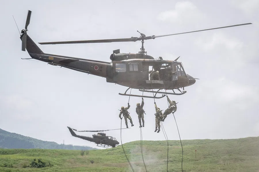 Japan Ground Self-Defense Forces soldiers rappel from a helicopter during a live fire exercise at East Fuji Maneuver Area in Gotemba, Japan, on 27 May 2023. (Yuichi Yamazaki/AFP)