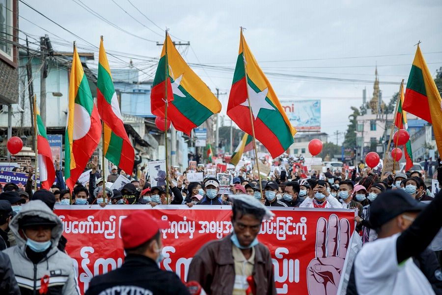 People take part in a demonstration against the 1 February military coup, along a street in the town of Muse in Shan state, near the China-Myanmar border on 8 February 2021. (STR/AFP)