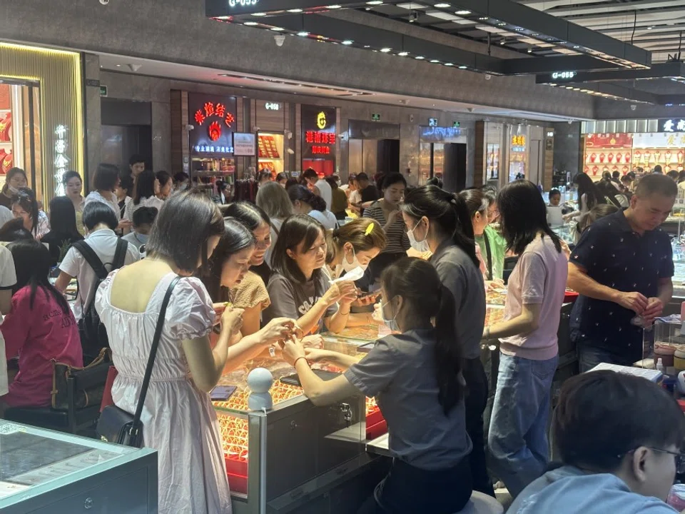 Young people looking at gold jewellery in Shuibei, Shenzhen, 18 June 2023. (SPH Media)