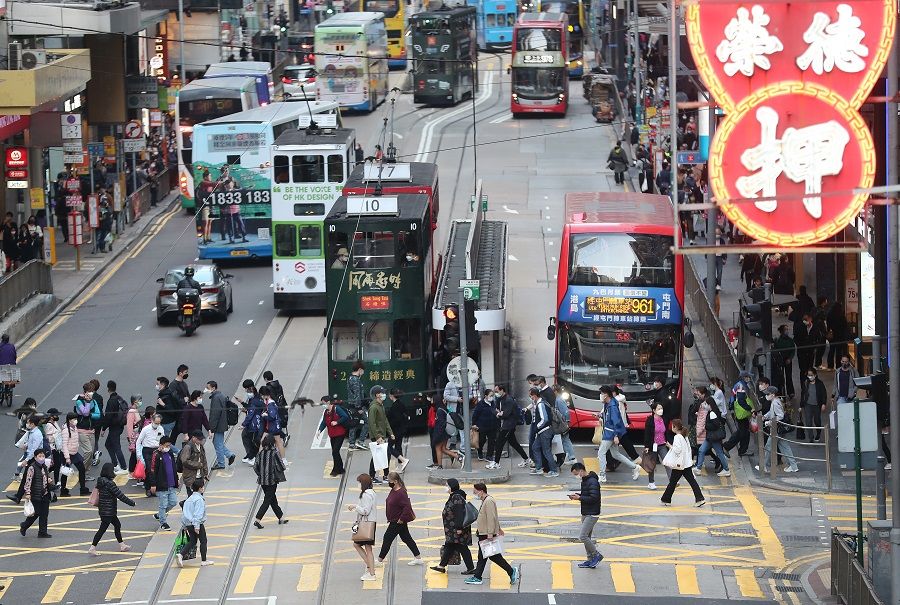 People cross a road in Hong Kong, China, 15 February 2023. (SPH Media)