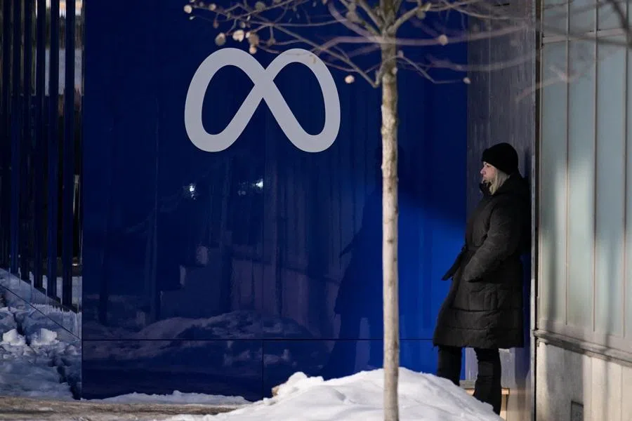 A woman stands near a Meta logo during the 56th annual World Economic Forum meeting, in Davos, Switzerland, on 20 January 2026. (Romina Amato/Reuters)