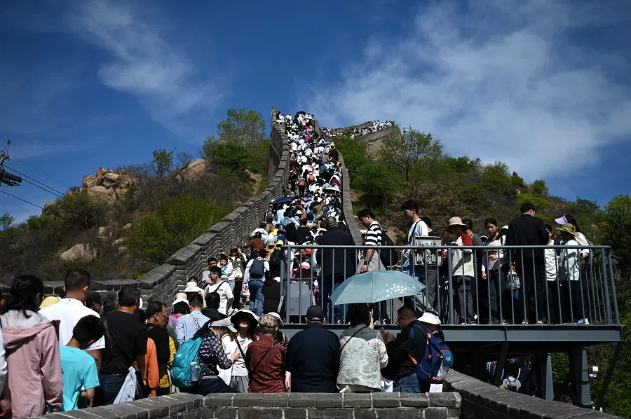 People climb the Great Wall of China at Badaling on 1 May 2024. (Greg Baker/AFP)
