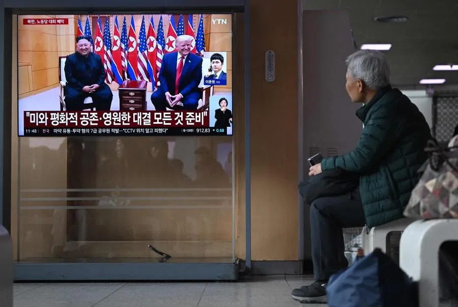 A man watches a television screen showing a news broadcast with a file photo of North Korea’s leader Kim Jong Un and US President Donald Trump, at a railway station in Seoul on 26 February 2026. (Jung Yeon-je/AFP)