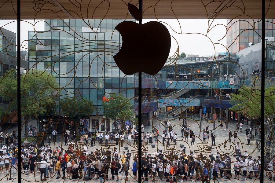 People line up outside the new Apple flagship store on its opening day following the Covid-19 outbreak, in Sanlitun, Beijing, China, on 17 July 2020. (Thomas Peter/Reuters)