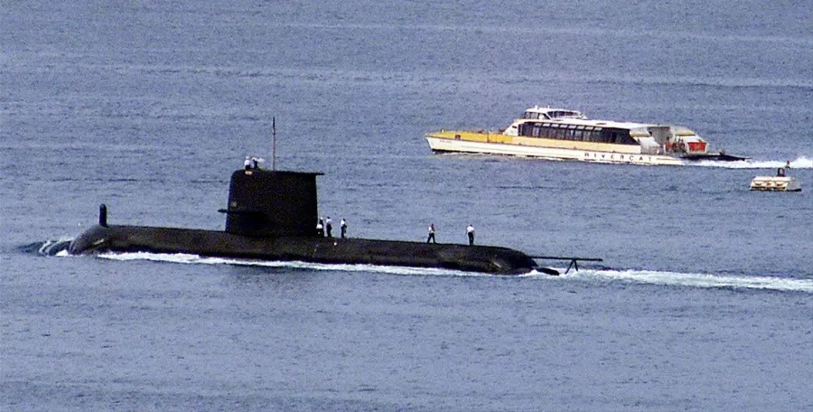 A Rivercat ferry passes by the Royal Australian Navy's Collins-class submarine HMAS Waller as it leaves Sydney Harbour on 4 May 2020. The Australian government has considered extending the life of the Collins class as it examines the fate of its next-generation sub program. (Reuters)
