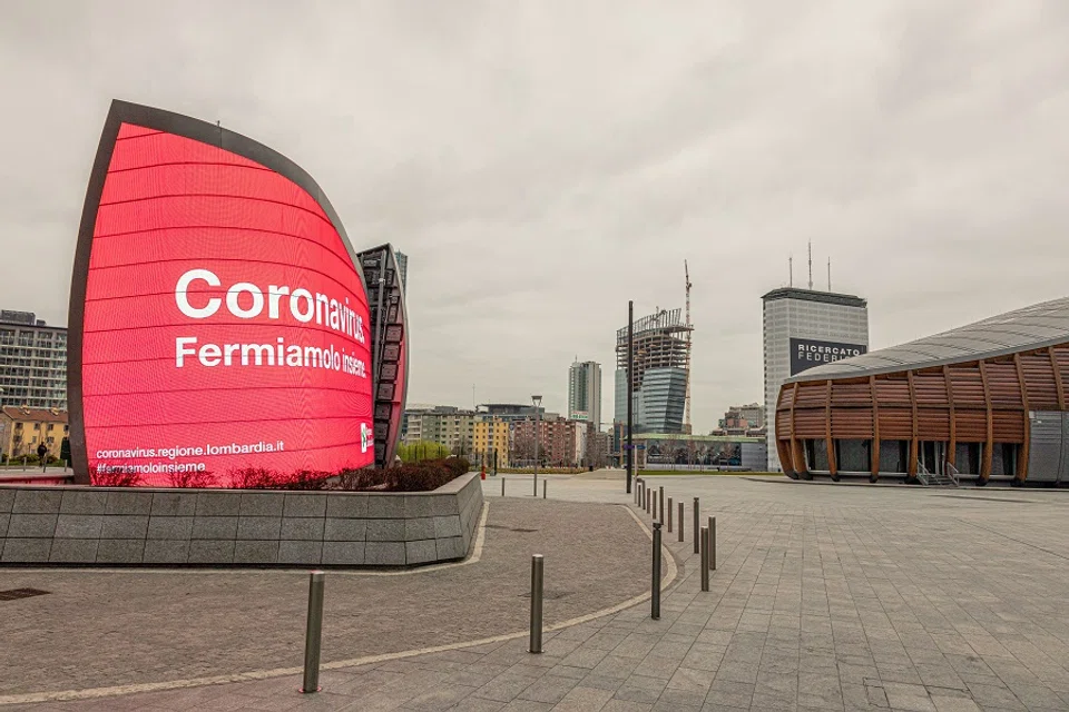 A Lombardy regional government notice reading "Coronavirus, Let's stop it together," sits on display on a digital billboard in Piazza Gae Aulenti in Milan, Italy, on 12 March 2020. (Alberto Bernasconi/Bloomberg)