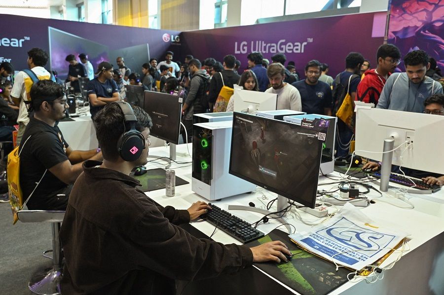 Visitors play computer games during the opening day of 'Bengaluru Comic Con 2022' in Bengaluru, India, on 19 November 2022. (Manjunath Kiran/AFP)