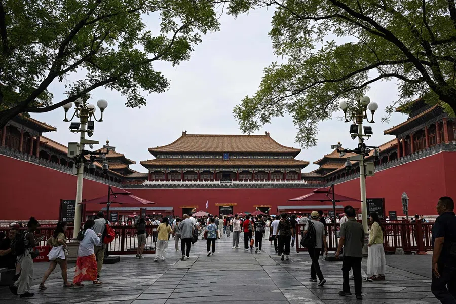 People walk to an entrance to the Forbidden City in Beijing on 10 September 2025. (Jade Gao/AFP)