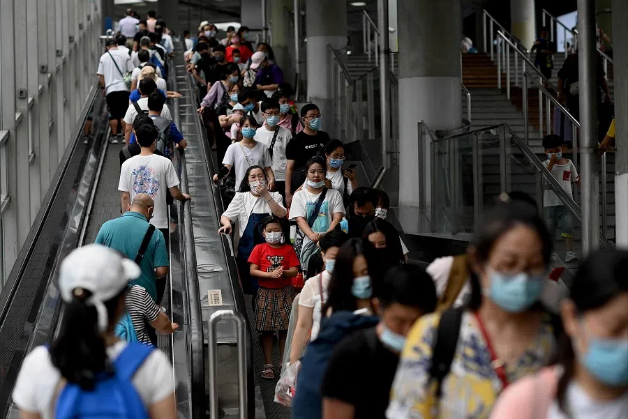 People ride escalators during rush hour at the subway in Beijing, China on 28 July 2021. (Noel Celis/AFP)
