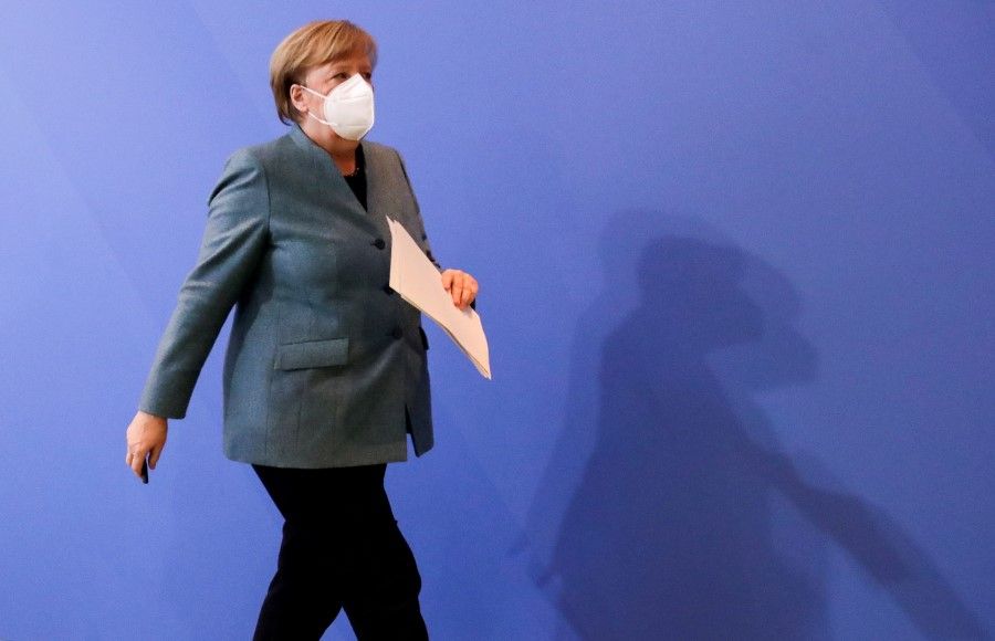 German Chancellor Angela Merkel leaves a news conference after meeting with vaccine producers and Germany's state prime ministers for a "vaccine discussion" via video conference, in Berlin, Germany, 1 February 2021. (Hannibal Hanschke/REUTERS)