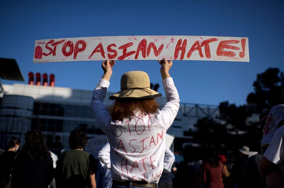 A person holds up a sign during a "Stop Asian Hate" rally at Discovery Green in Houston, Texas, US, on 20 March 2021. (Mark Felix/AFP)