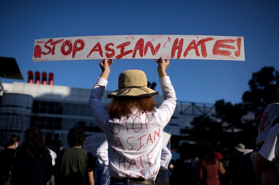 A person holds up a sign during a "Stop Asian Hate" rally at Discovery Green in Houston, Texas, US, on 20 March 2021. (Mark Felix/AFP)
