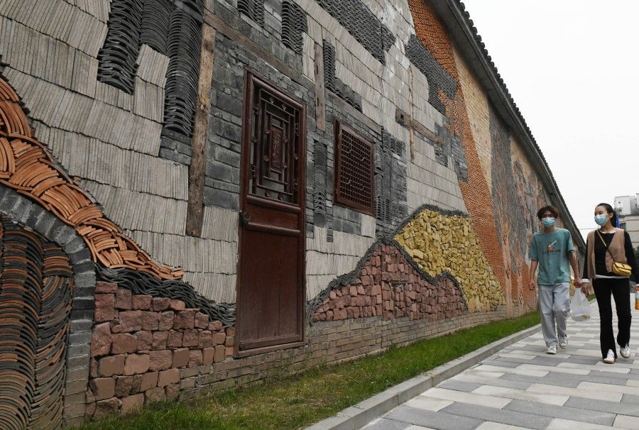 People walk past a mural in Yubei district, Chongqing, China, 3 November 2022. (CNS)