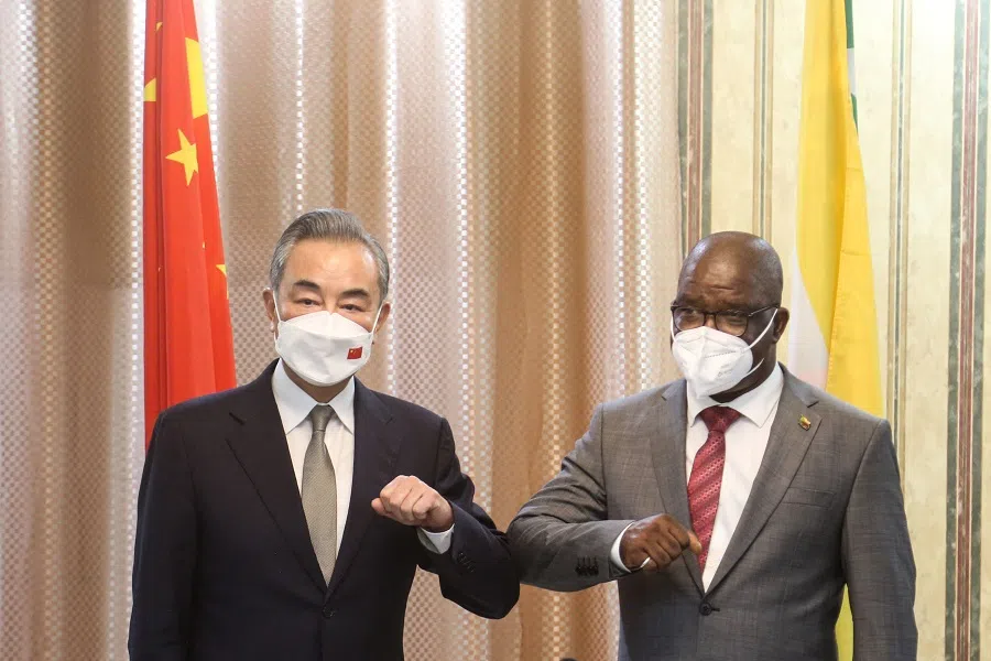 Union of Comoros' Minister of Foreign Affairs Dhoihir Dhoulkamal (right) welcomes China's Foreign Affairs Minister Wang Yi, ahead of a meeting, in Moroni, Comoros, on 6 January 2022. (Ibrahim Youssouf/AFP)