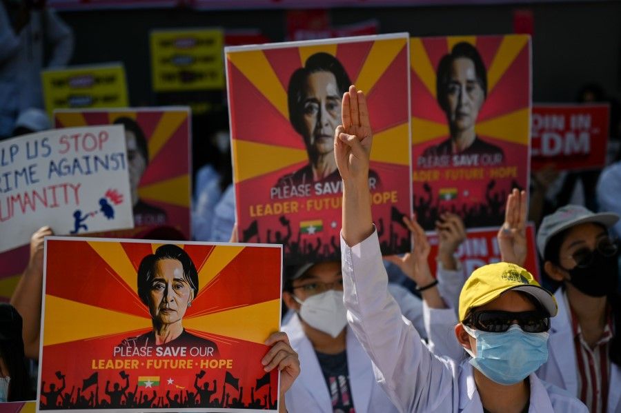 Protesters hold up the three finger salute during a demonstration against the military coup outside the Chinese embassy in Yangon on 15 February 2021. (Ye Aung Thu/AFP)