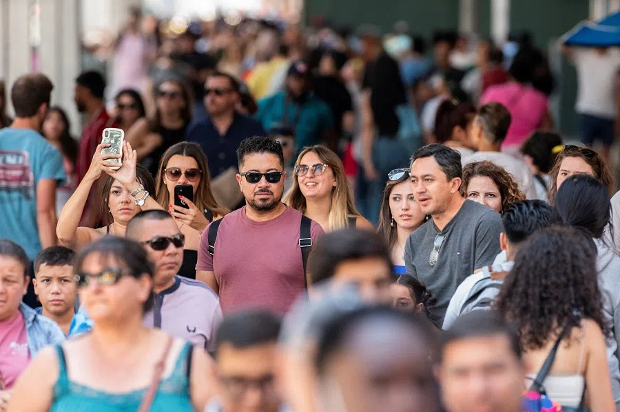 People make their way in a crowded street at Times Square, in New York, US, 12 August 2022. (Eduardo Munoz/Reuters)