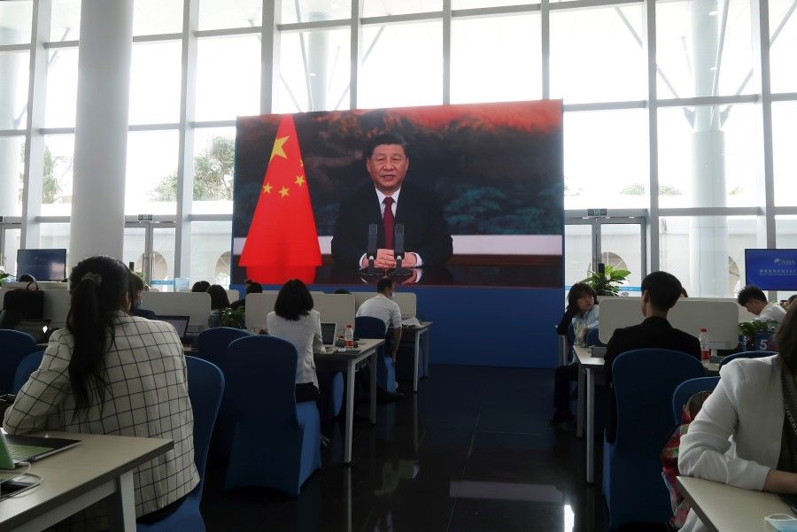 Chinese President Xi Jinping is seen on a giant screen at a media centre, as he delivers via video link a keynote speech at the opening ceremony of the Boao Forum for Asia, in Boao, Hainan province, China, 20 April 2021. (Kevin Yao/Reuters)