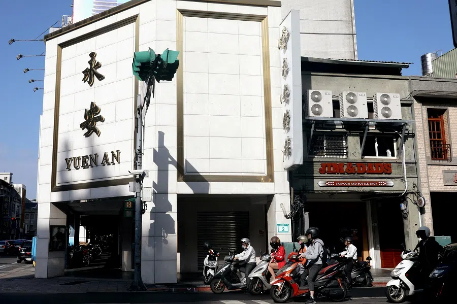 Motorbikes drive past apartments during a rush hour in Taipei, Taiwan, 15 October 2020. (Ann Wang/Reuters)