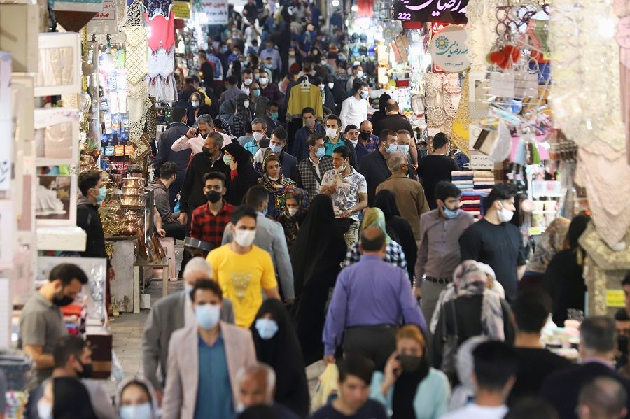 People walk in Tehran Bazaar, in Tehran, Iran, 6 April 2021. (Majid Asgaripour/West Asia News Agency via Reuters)