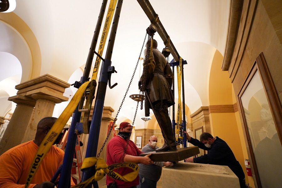 People work on the removal of the statue of Confederate General Robert E. Lee from the US Capitol crypt on Capitol Hill in Washington, US, 21 December 2020. (Jack Mayer, Office of Governor Northam/Handout via Reuters)