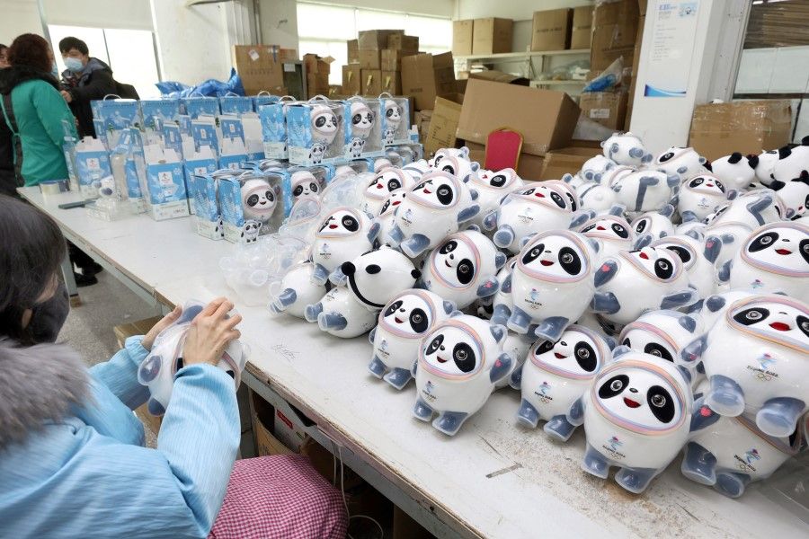 An employee works on stuffed toys of 2022 Beijing Winter Olympic Games mascot Bing Dwen Dwen at a factory in Nantong in China's eastern Jiangsu province on 8 February 2022. (AFP)