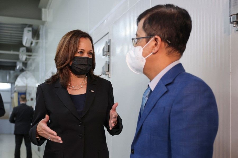 US Vice-President Kamala Harris speaks with the director of the National Institute of Hygiene and Epidemiology Dang Duc Anh, as she visits the NIHE where 270,000 doses of Pfizer vaccine arrived earlier in the morning, in Hanoi, Vietnam, 26 August 2021. (Evelyn Hockstein/AFP)